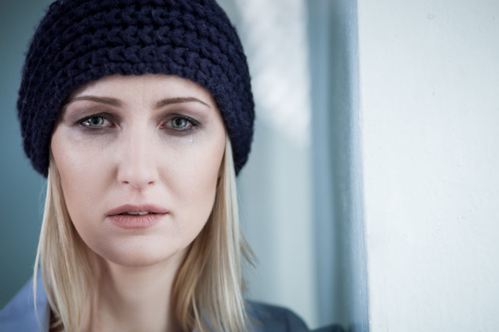 Depressed blond female druggie is weeping for loneliness